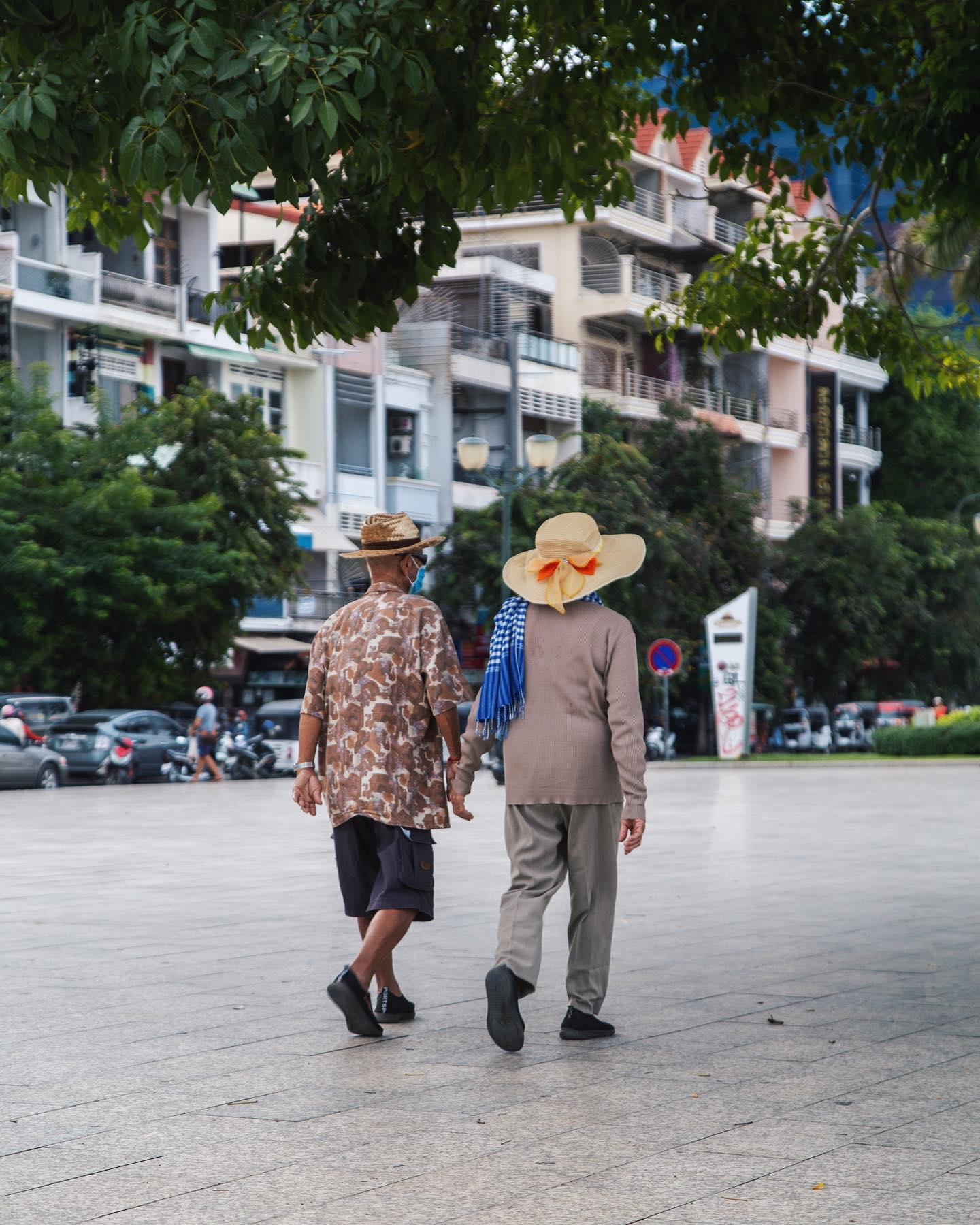 Two people walking together through Phnom Penh