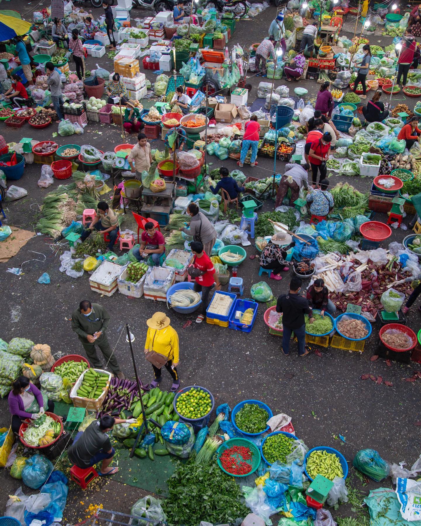 An overhead view of a busy produce market in Phnom Penh