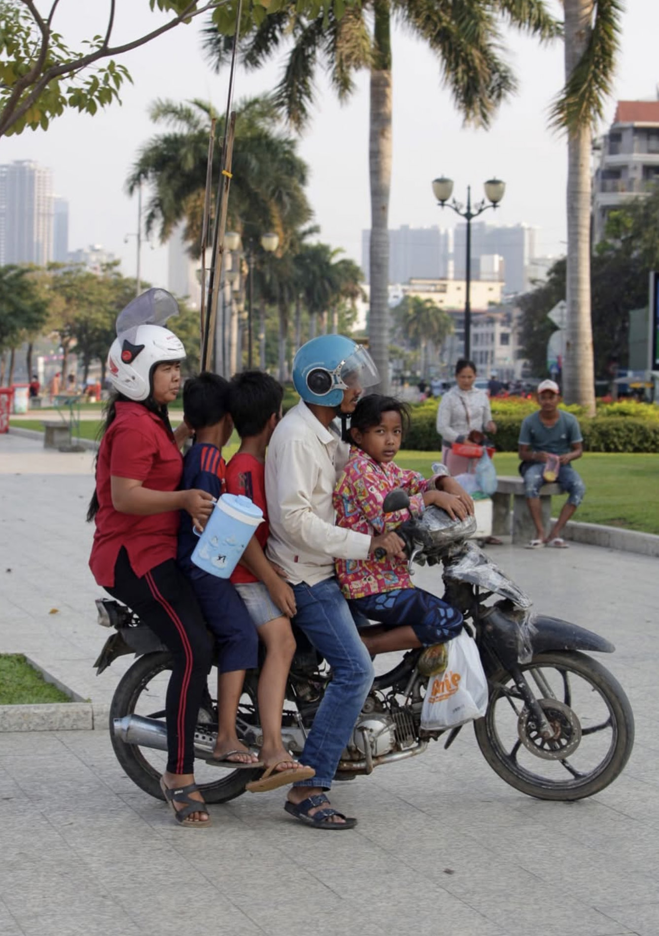 A family travelling together through Phnom Penh