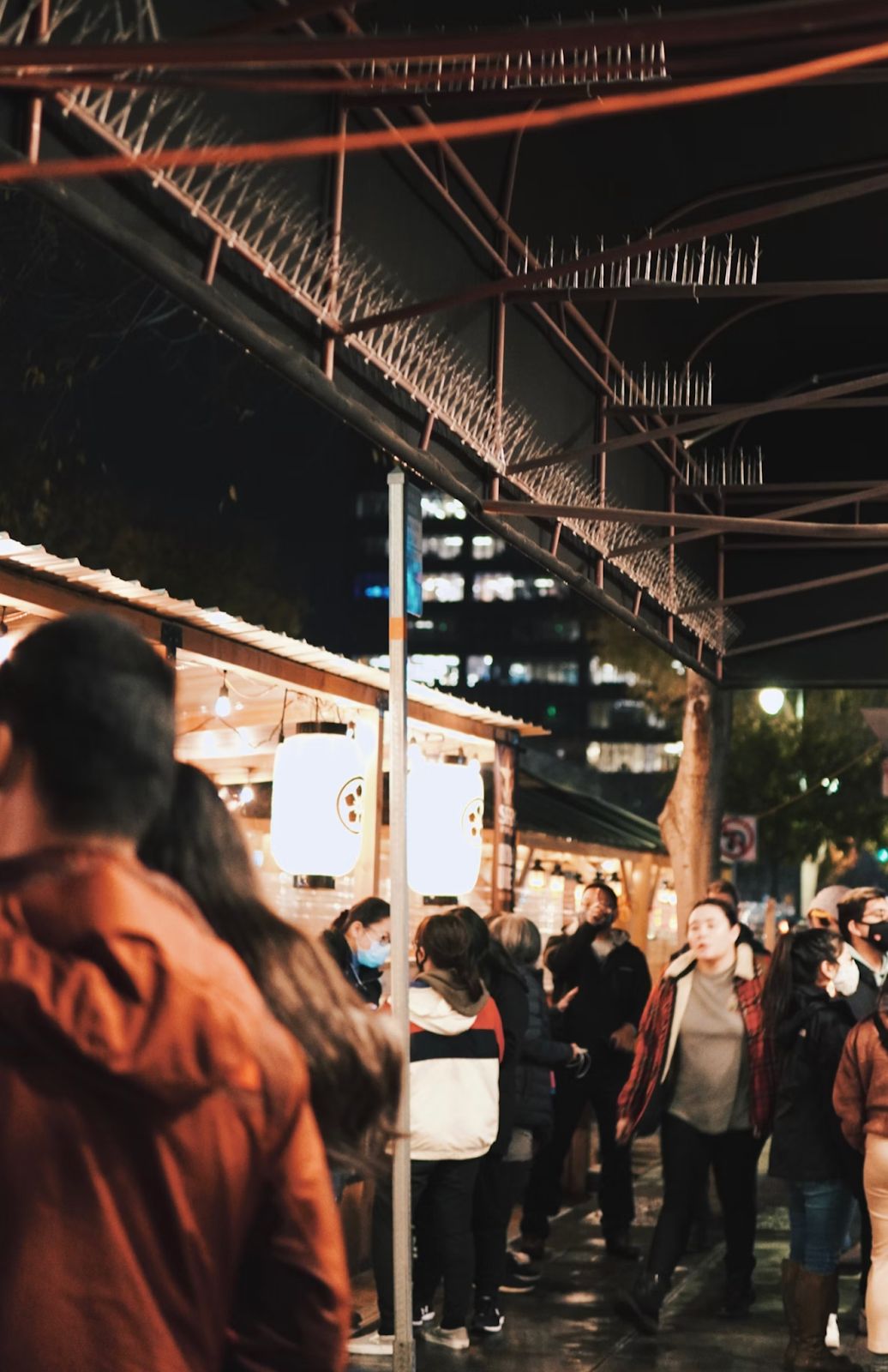 A night gathering beneath a city roof
