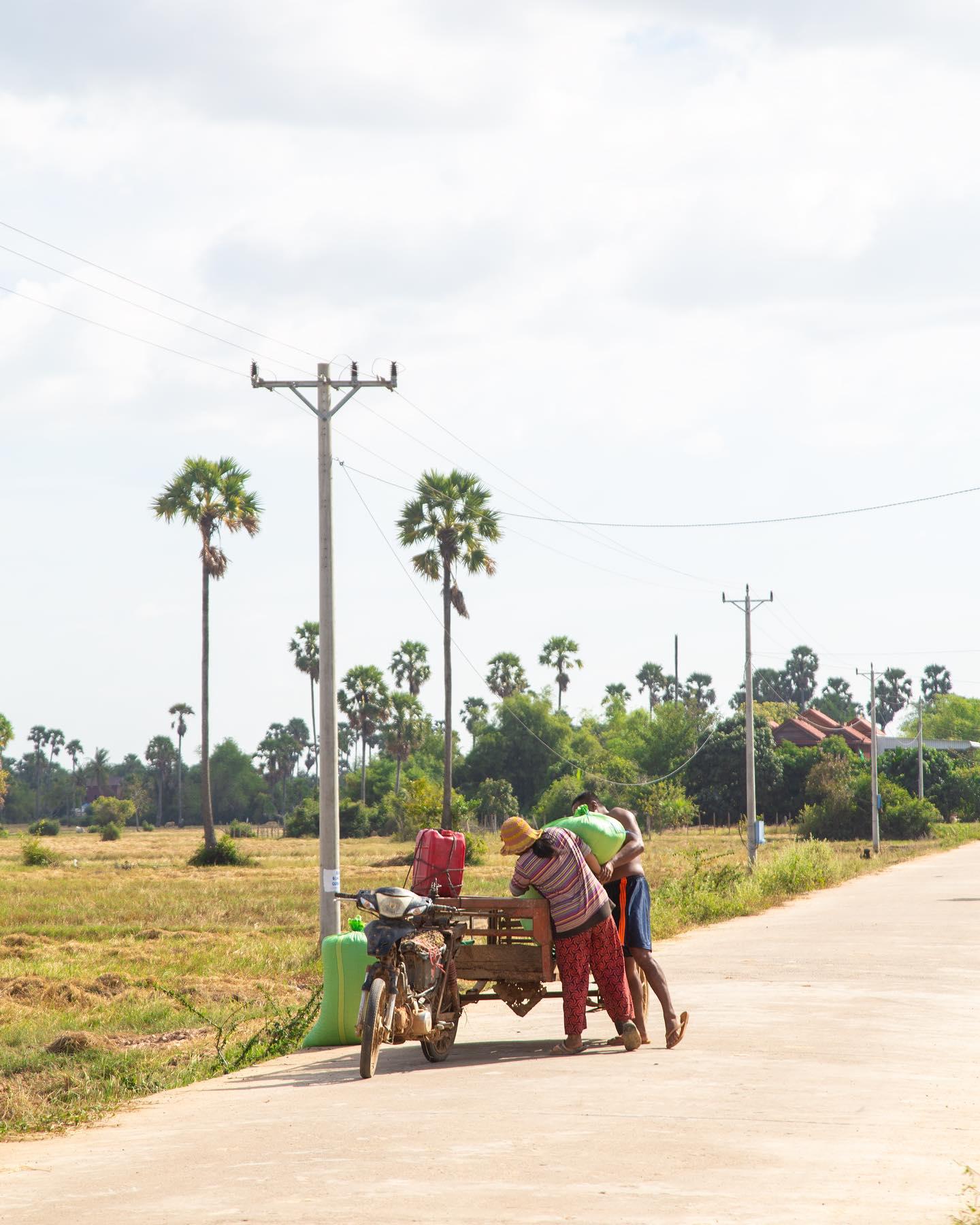 People travelling together along a rural Cambodian road