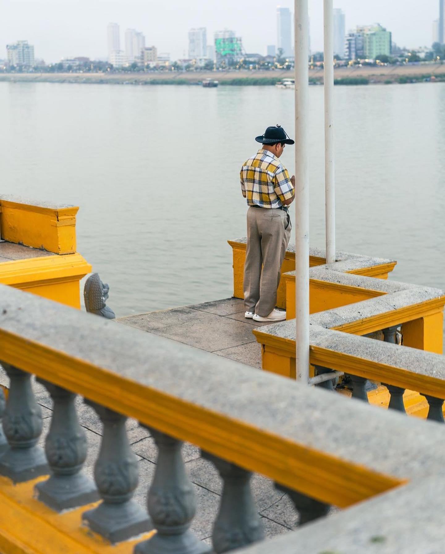 A person pausing beside the river
